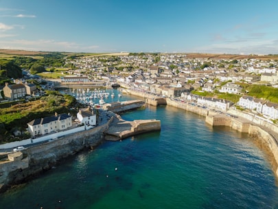 Aerial view of a coastal town with marinas, golf courses, and beachfront properties under clear skies.
