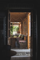 A cozy outdoor seating area with natural stone and wooden furniture.
