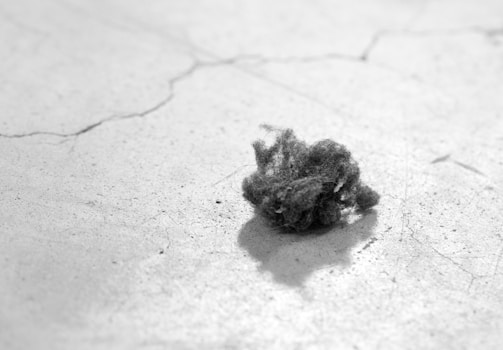 A close-up of dust and allergens being removed from ducts.