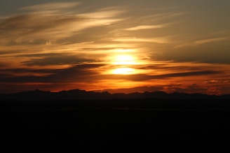 Sunset casting a golden glow over Moreno's Farm with the mountain silhouette in the background.
