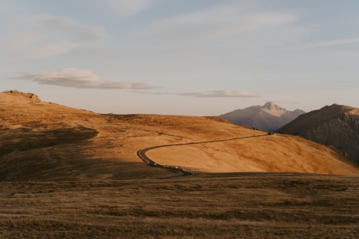 A winding road through a scenic landscape showcasing vast horizons.
