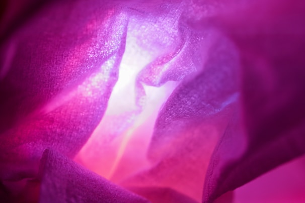 A close-up of a textured abstract digital painting with soft pink and gold accents.