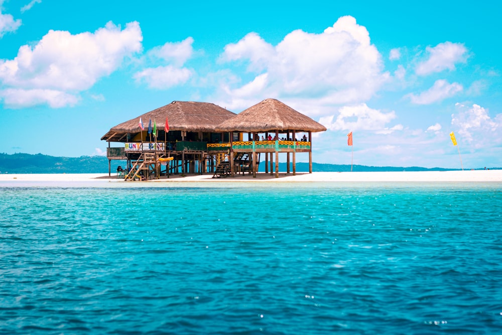 brown wooden cottage in an islet during daytime