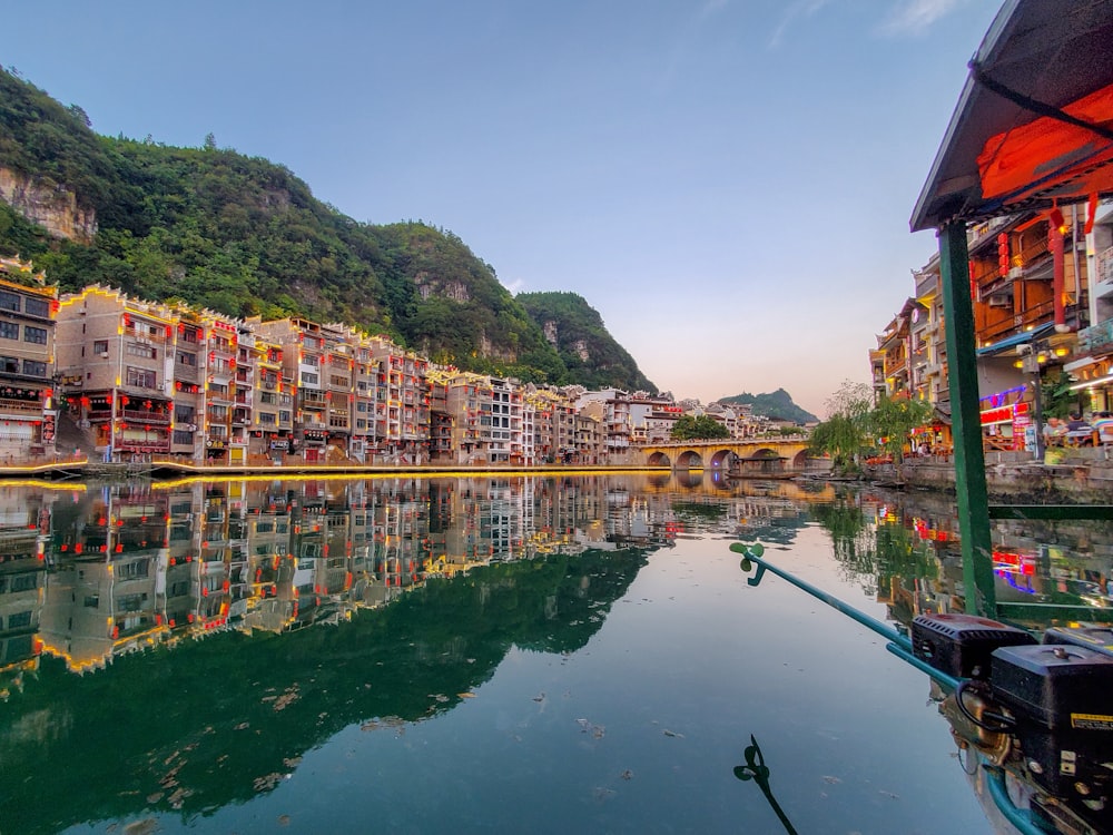reflection of colorful buildings on body of water