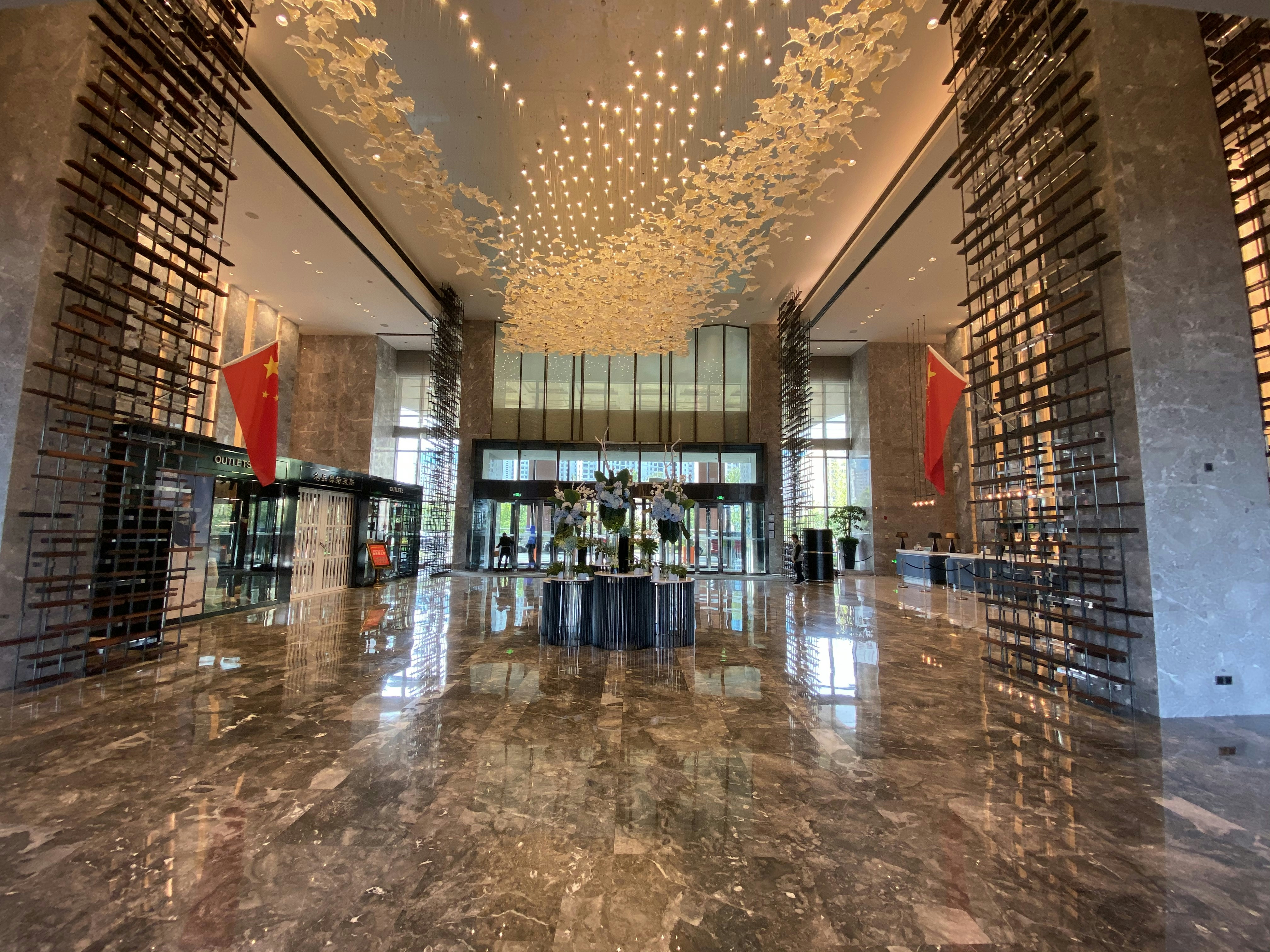 Grand clubhouse lobby with high ceilings, marble floors, bright open interior design