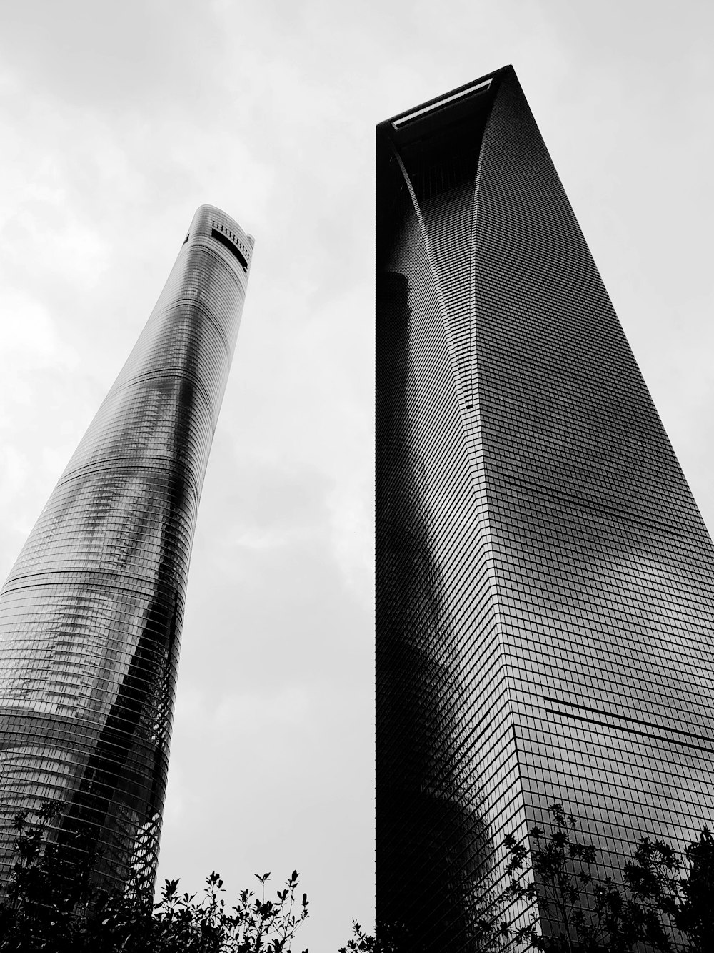 low-angle photography of two high-rise glass buildings