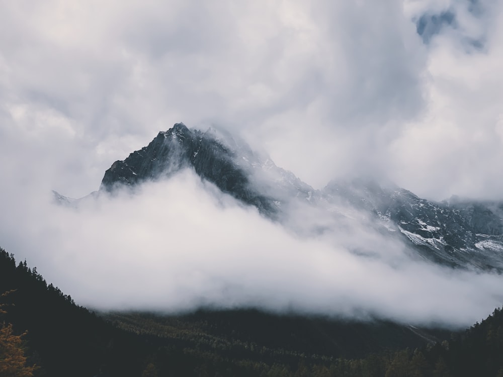 green mountain covered with white clouds