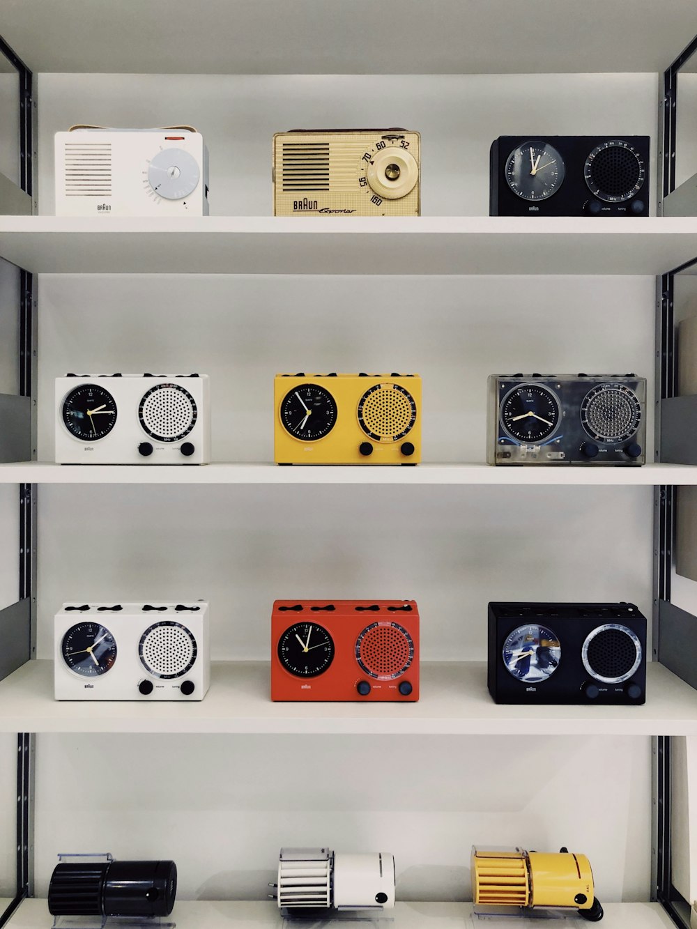 assorted-color portable alarm clocks displayed on a rack