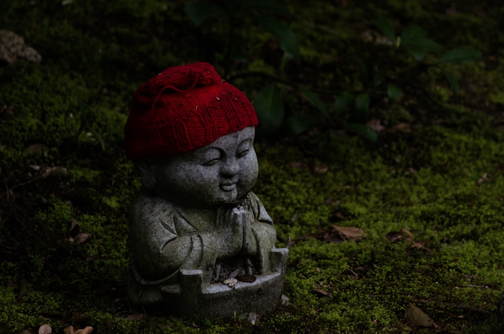 Buddha statue wearing red knitted hat
