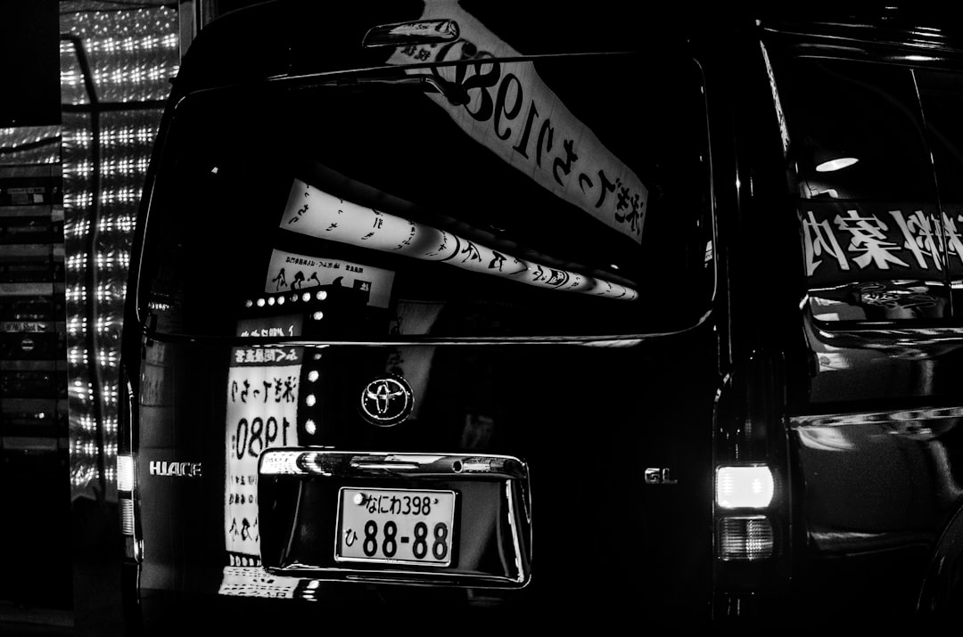 grayscale photography of a Toyota van