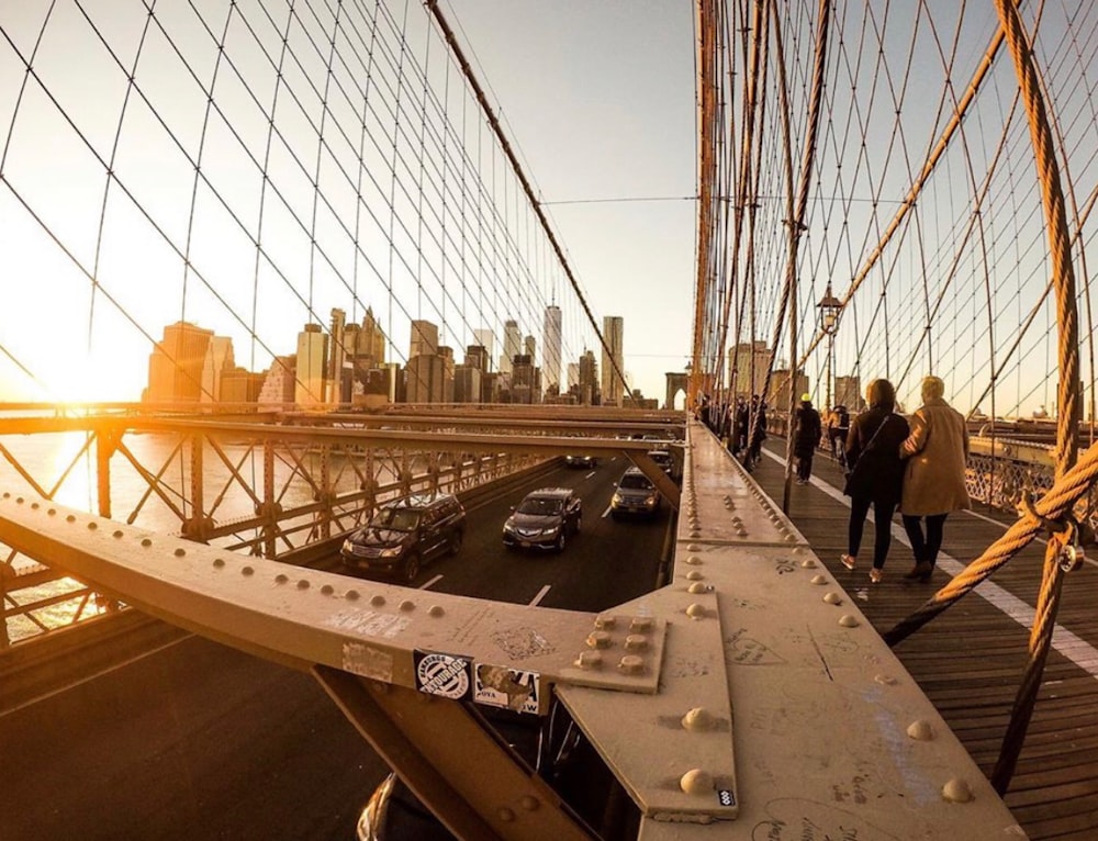 photography of vehicle across on bridge during daytime