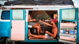 Happy travelers enjoying a meal inside their campervan equipped with modular furniture