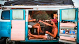 Close-up of Lore and Jose smiling inside their cozy camper kitchen