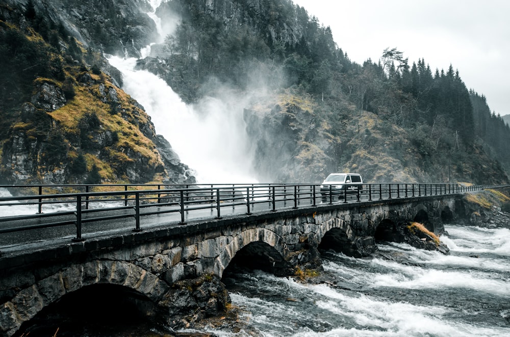 waterfalls running near bridge