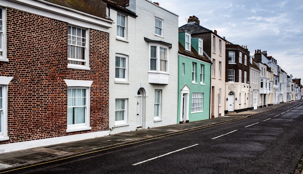 line of buildings beside sidewalk and road