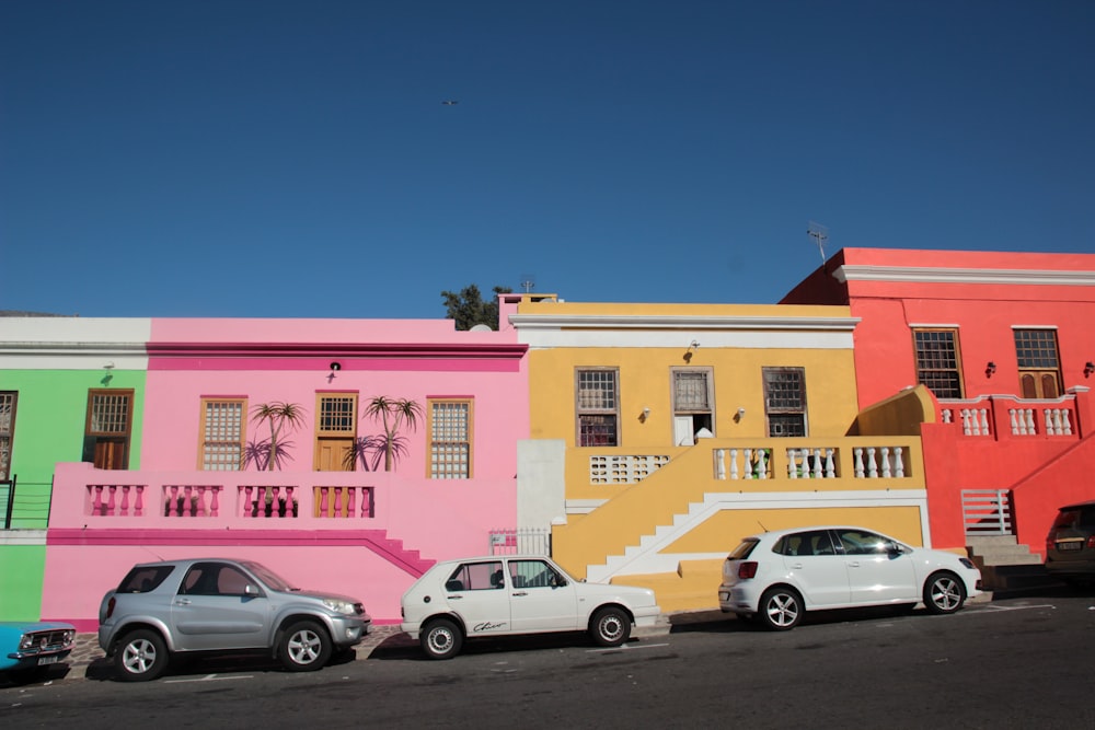 parked cars near multi-colored house