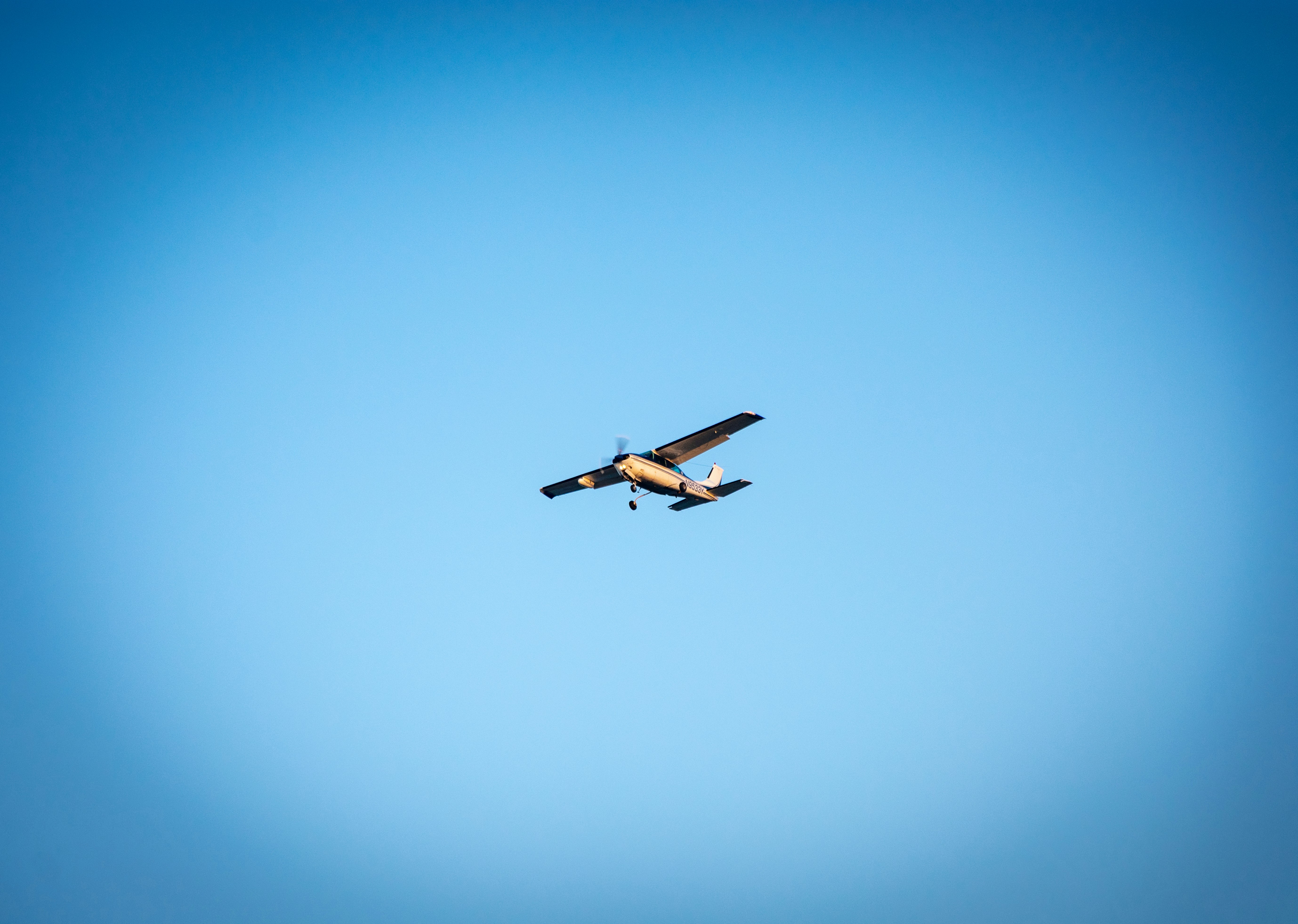 brown monoplane under blue sky