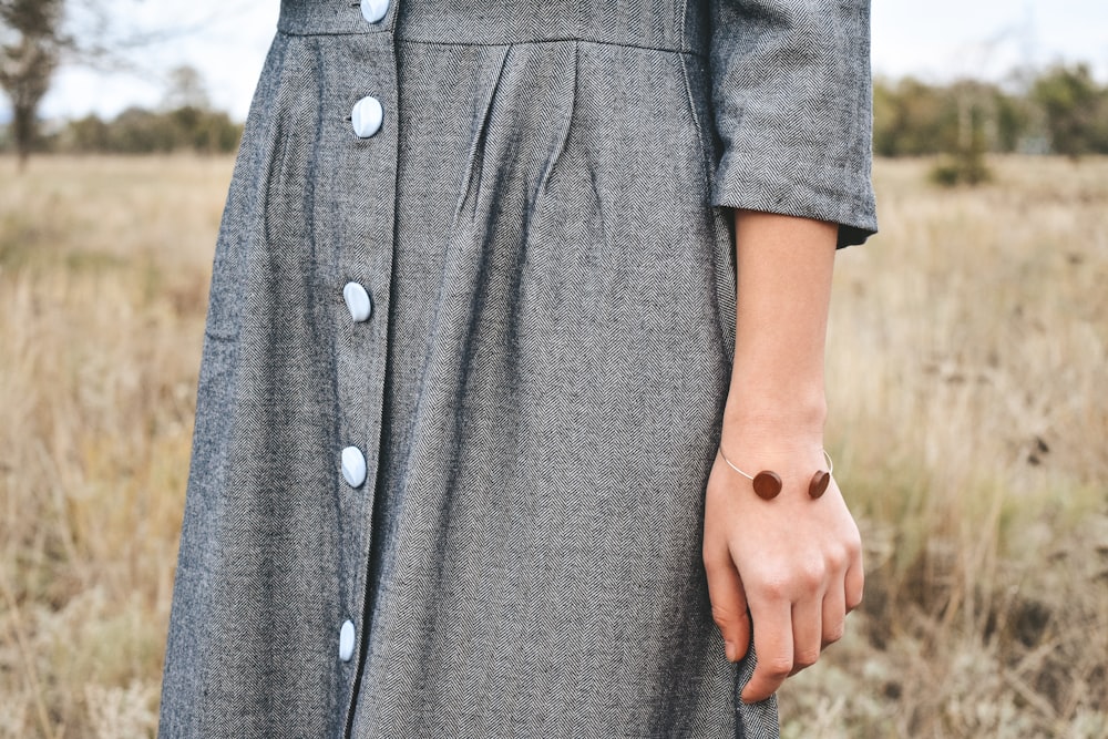 woman wearing black button-up long-sleeved dress