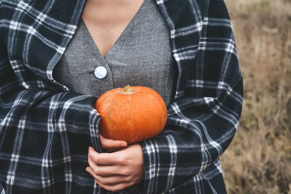 person holding red squash