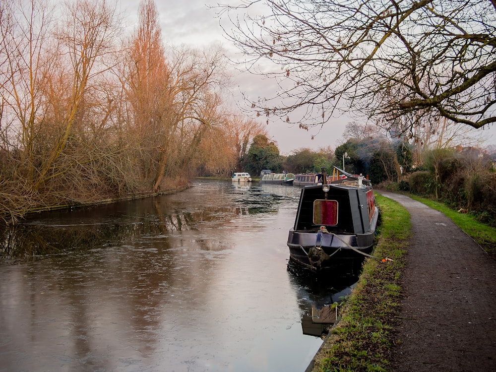 black boat on body of water during daytime