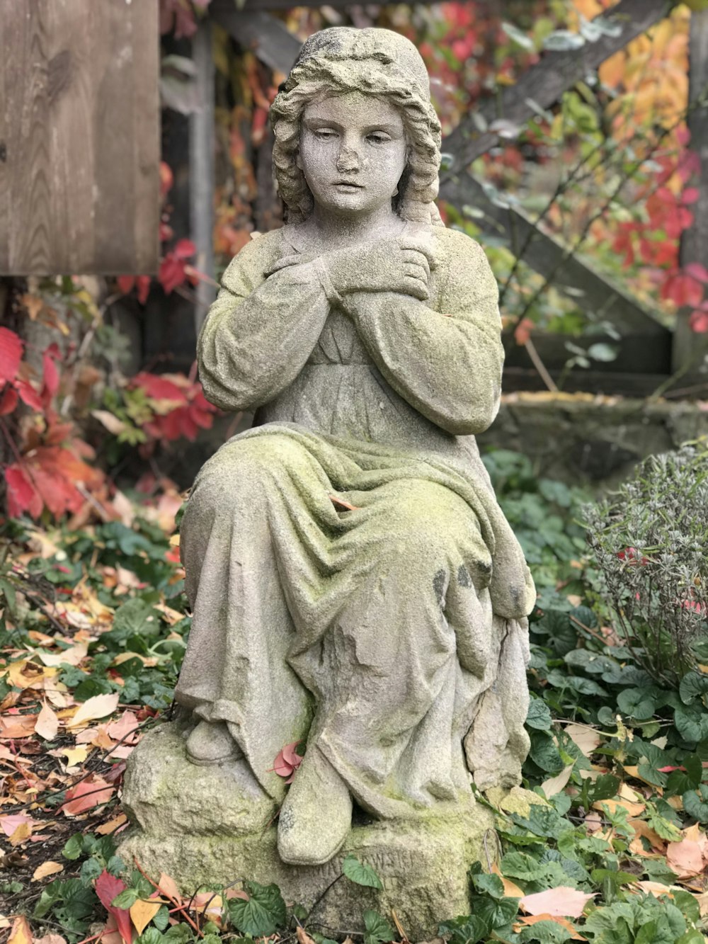 girl sitting on rock statue