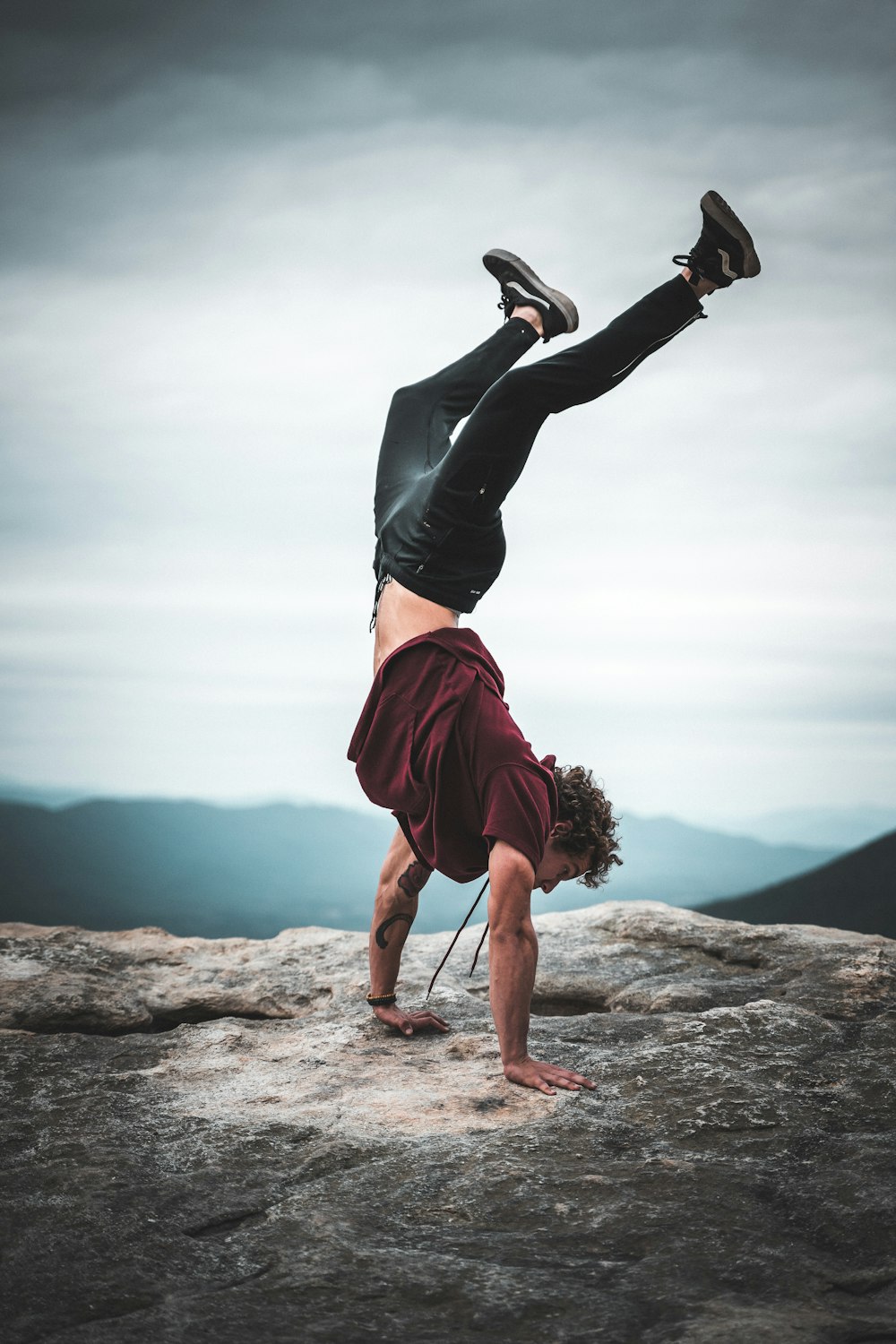 man doing stunt with maroon shirt