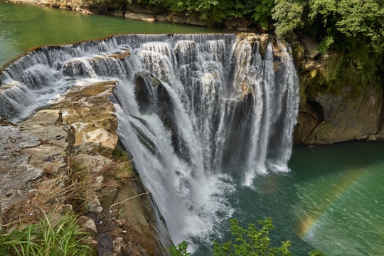 waterfall and green leafed trees in Shifen waterfall Taiwan