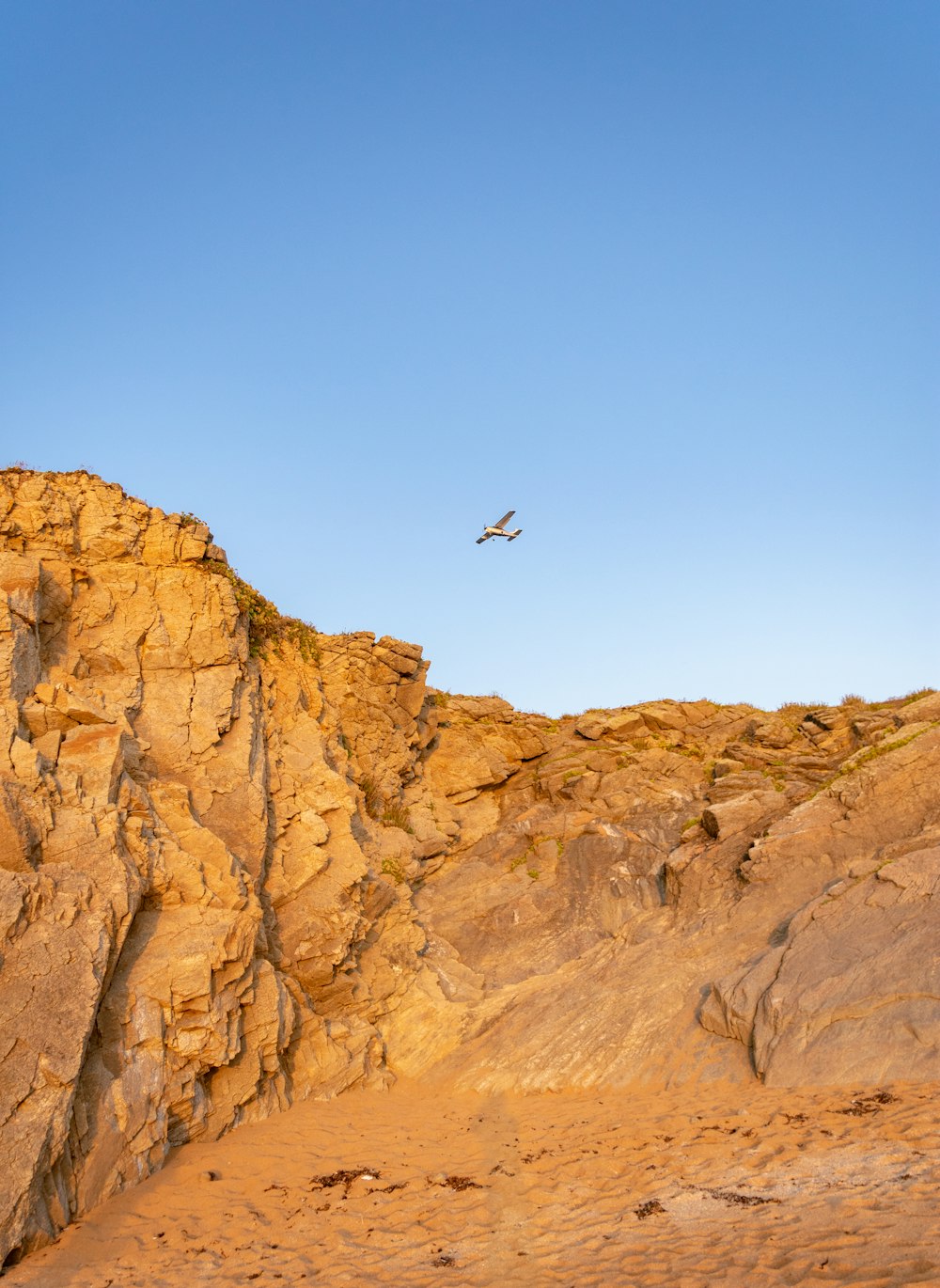 white airplane above mountains during day