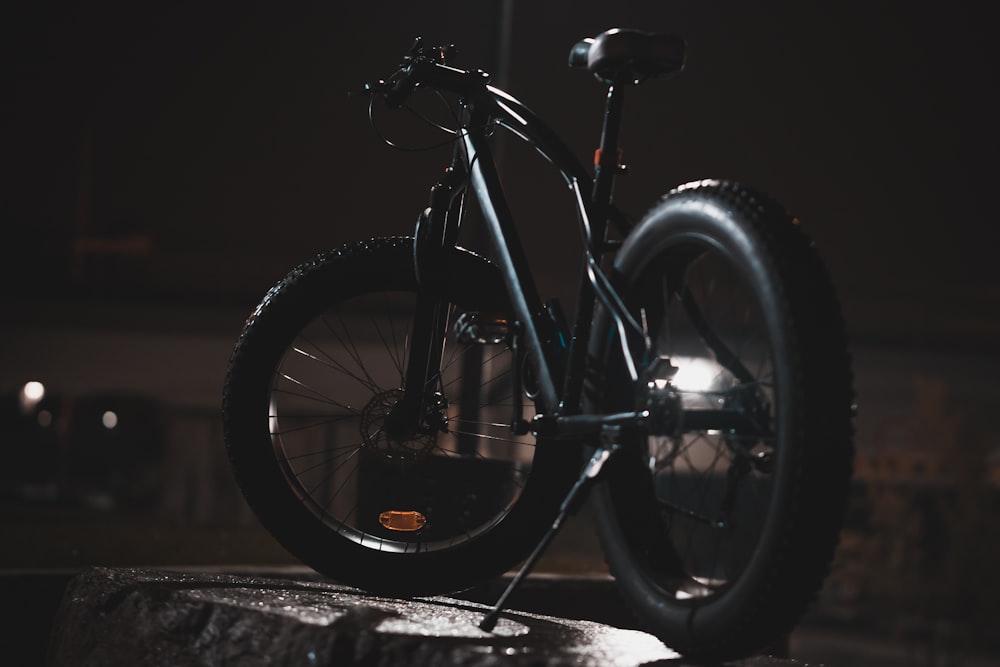 black cruiser bike on gray surface