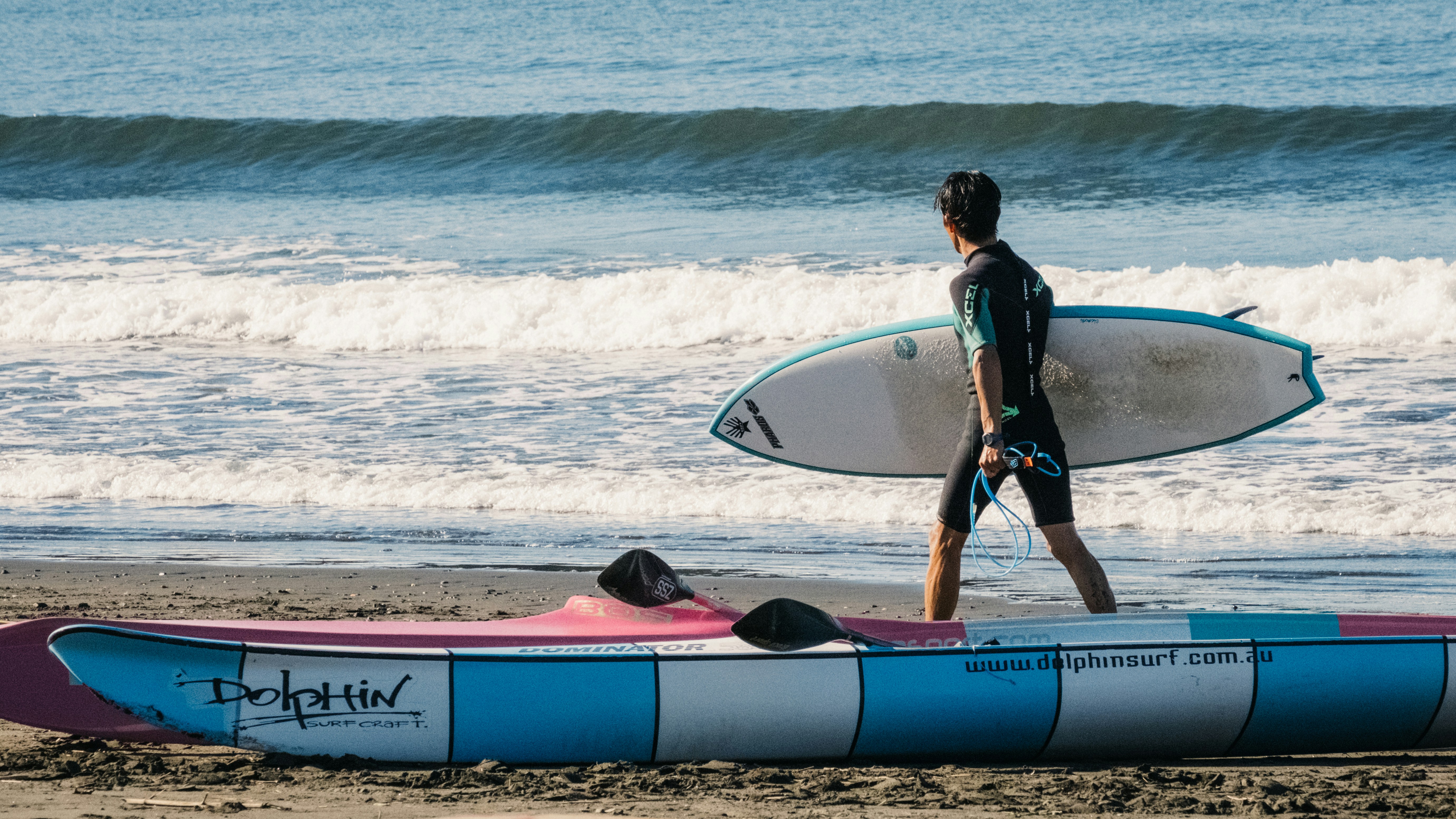 man holding surfboard during daytime