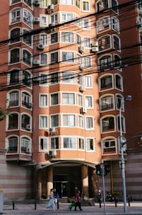 people in front of brown building during daytime