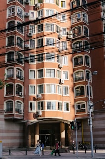 people in front of brown building during daytime