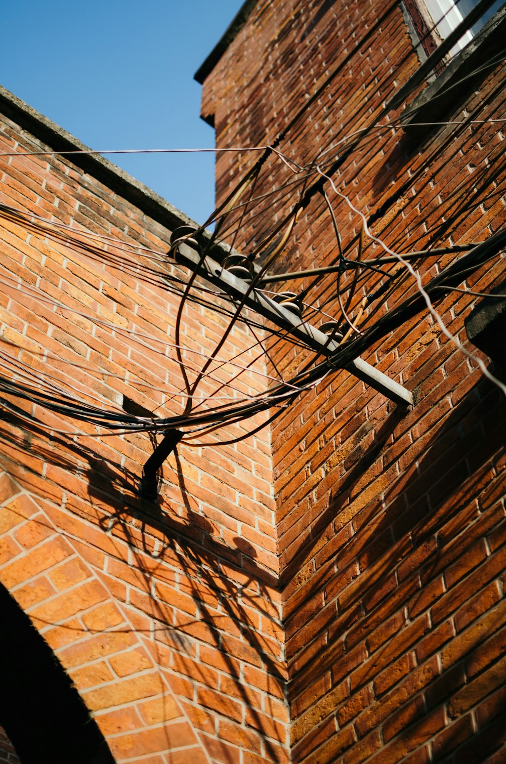 black cables wires on brown wall