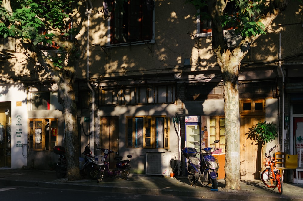 motorcycles and bikes parked beside building during day