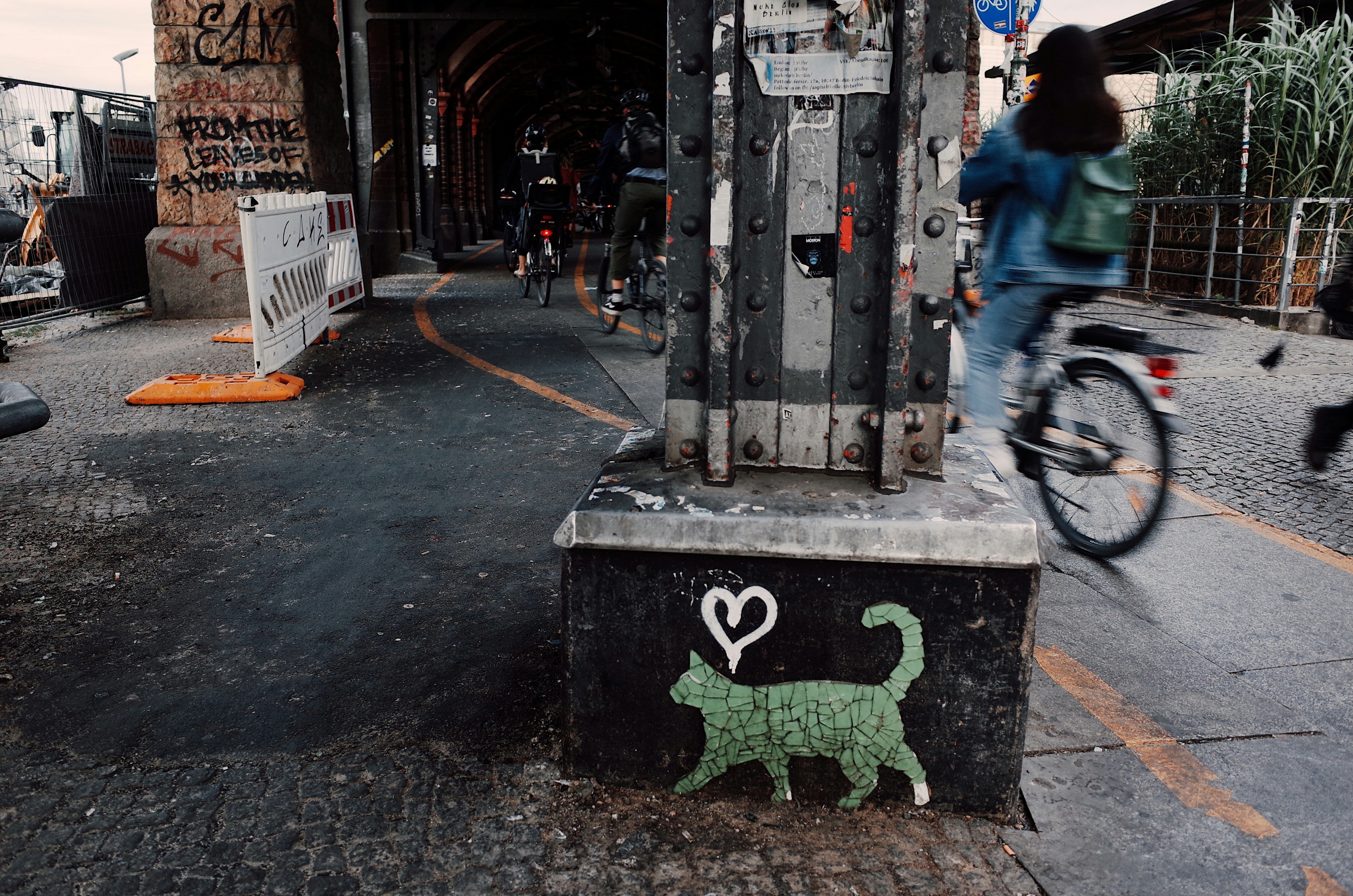 people riding bikes near pillars during day