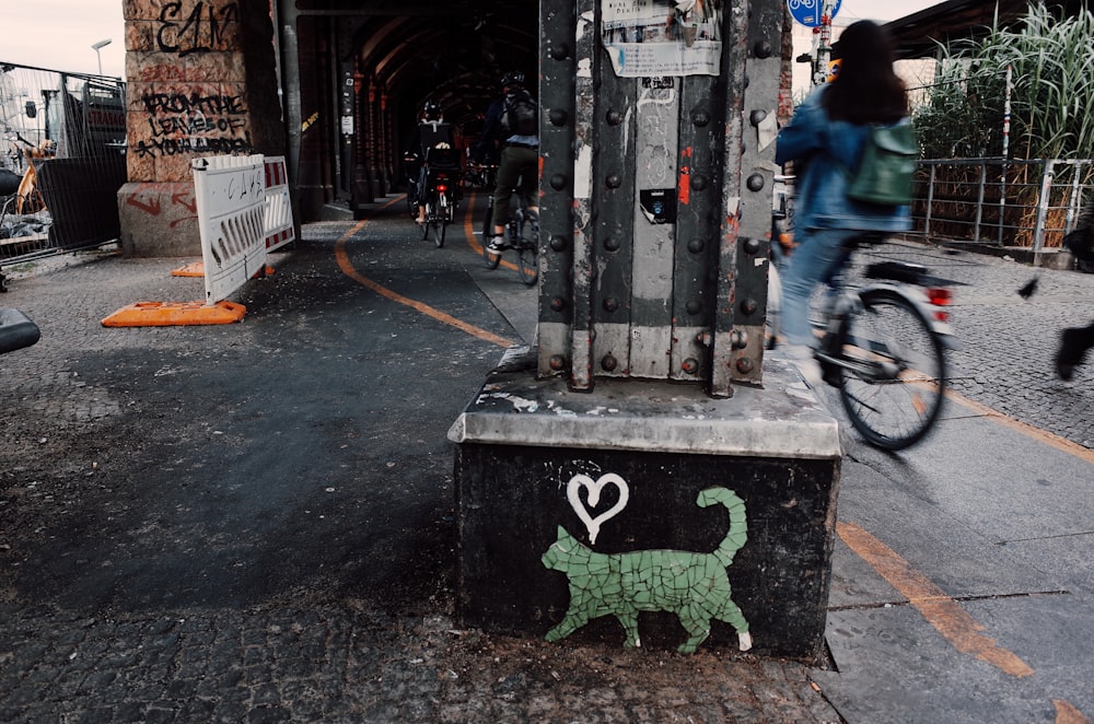 people riding bikes near pillars during day