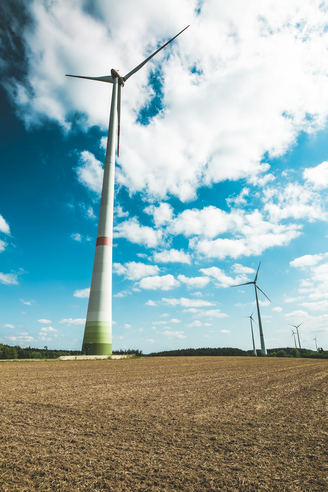 wind turbines under cloudy sky