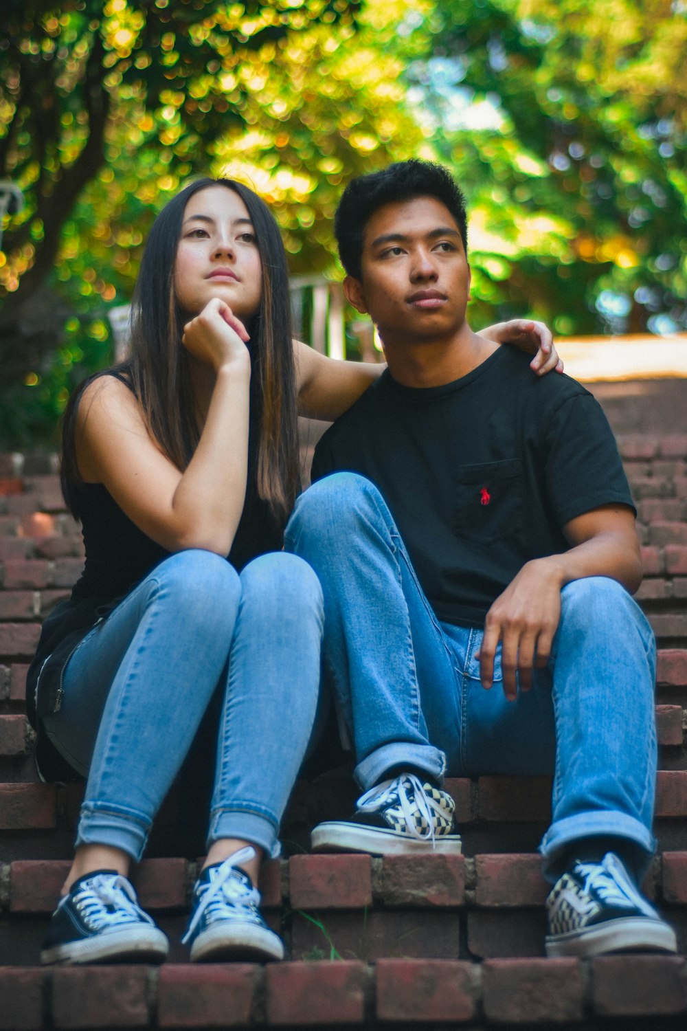 man and woman sitting on concrete stairs