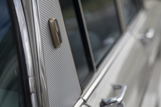 Close-up of a car being carefully detailed, showing shiny clean surfaces and interior.