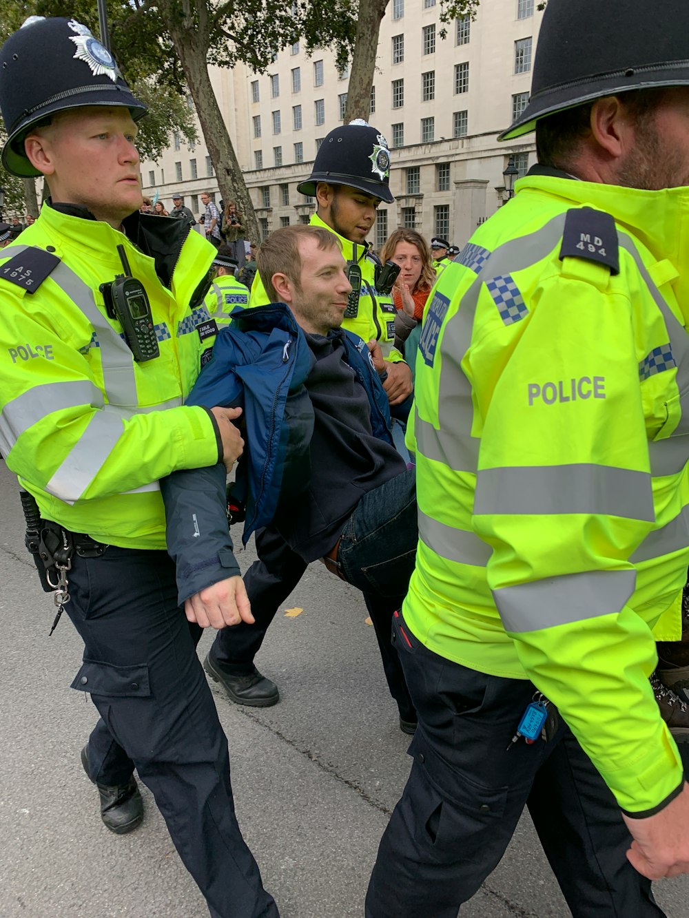 four policemen carrying men