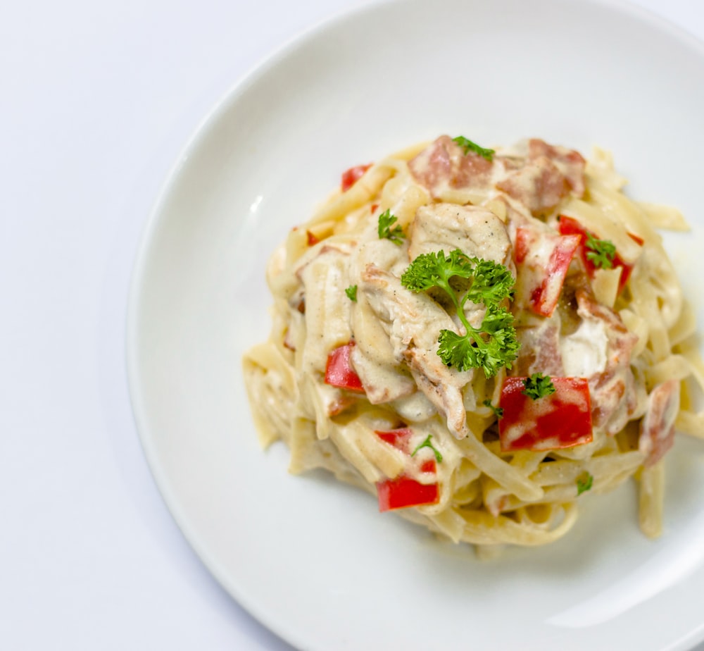 plate of white pasta with red bell pepper