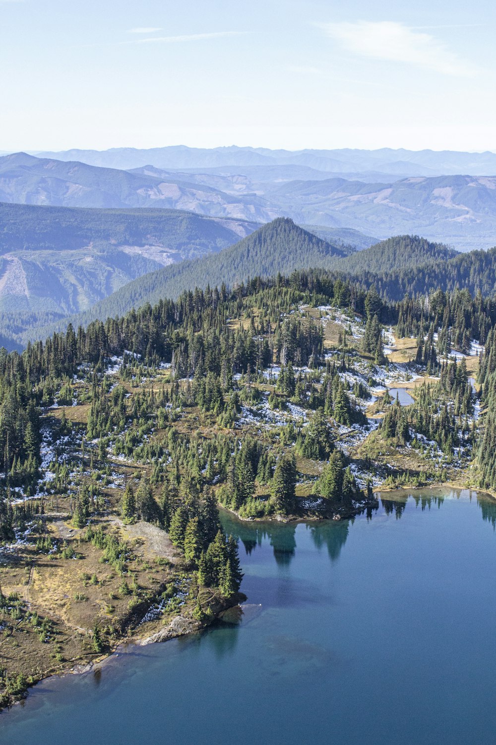 aerial photography of green mountains under a calm blue sky