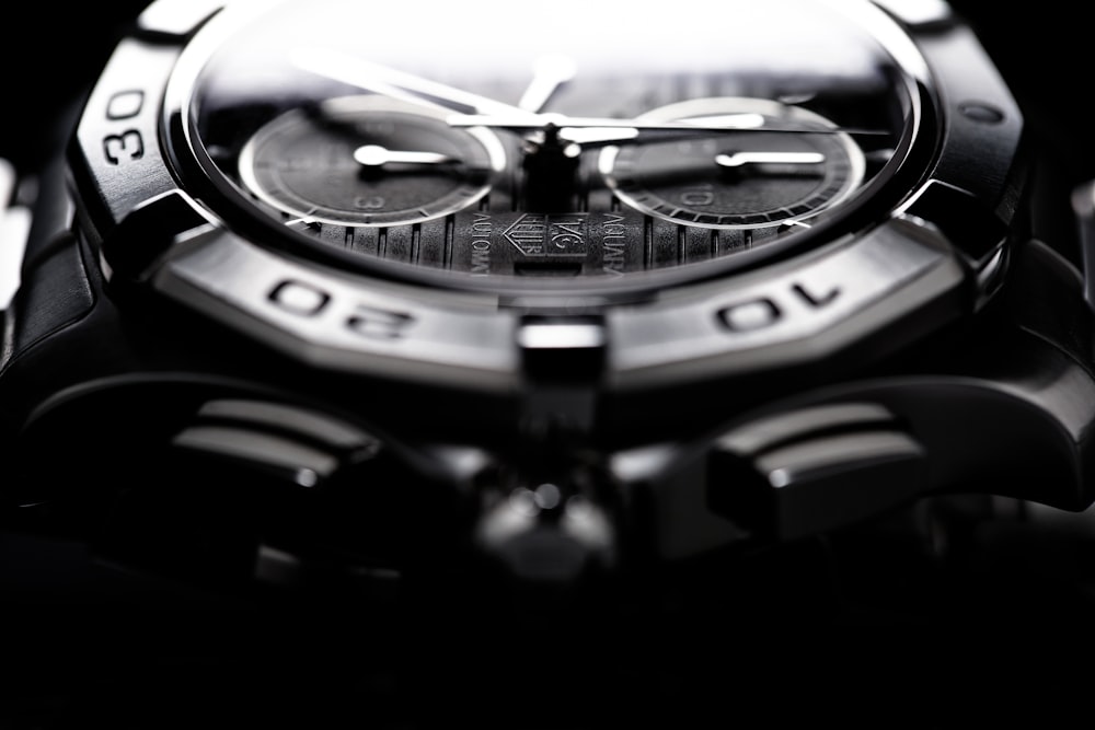shallow focus photo of round chronograph watch