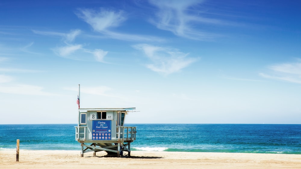 gray wooden house on beach