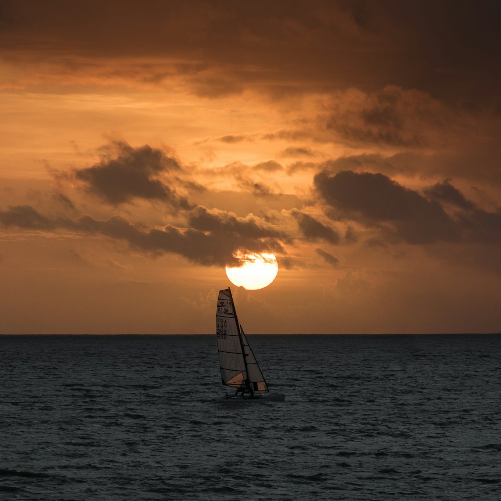 gray sailboat on ocean during daytime