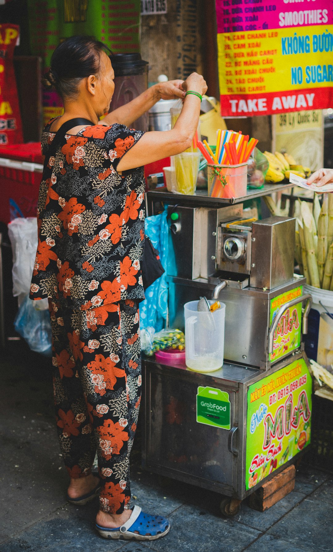 woman wearing black, orange, and black floral shirt and pants