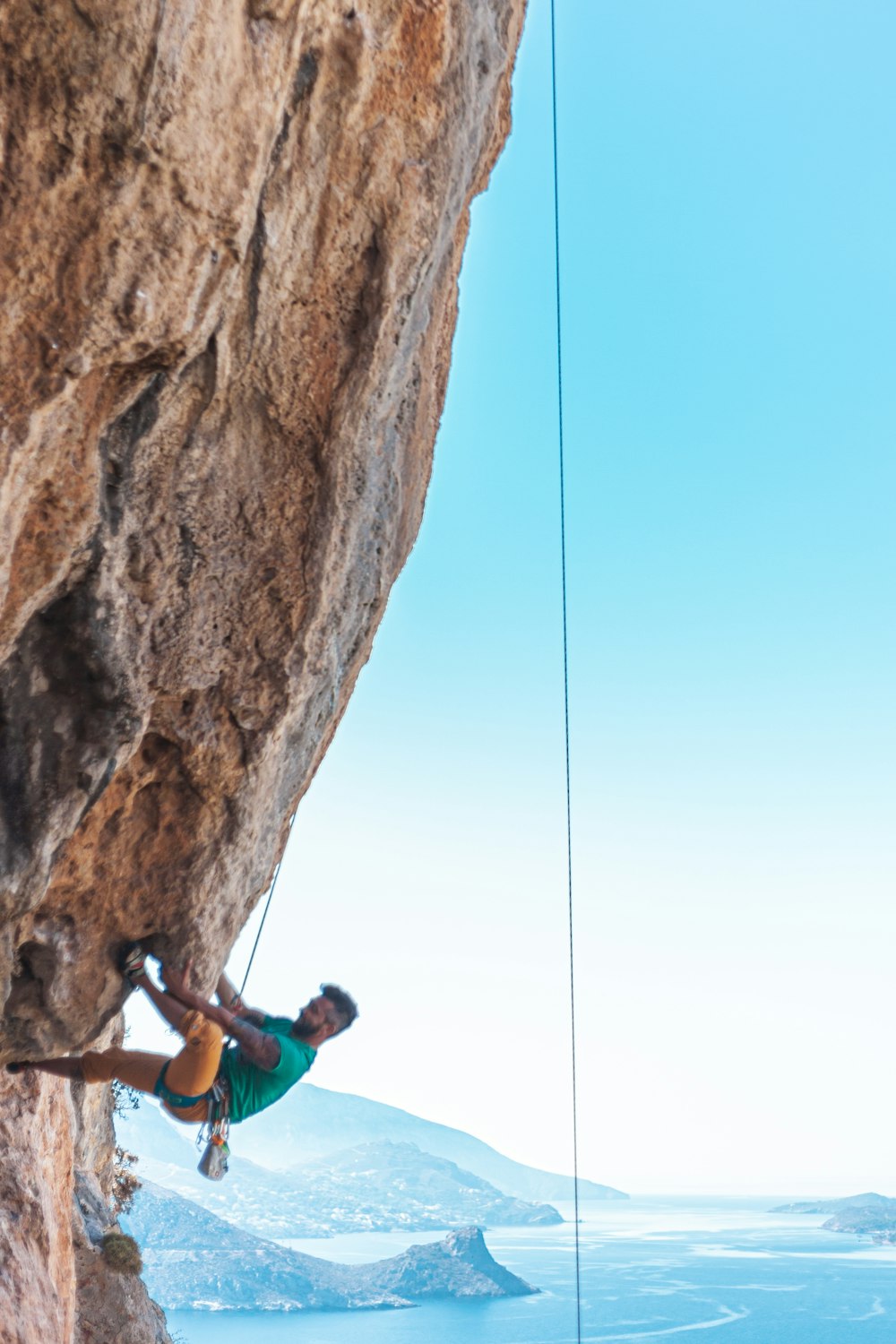 man rock climbing during daytime