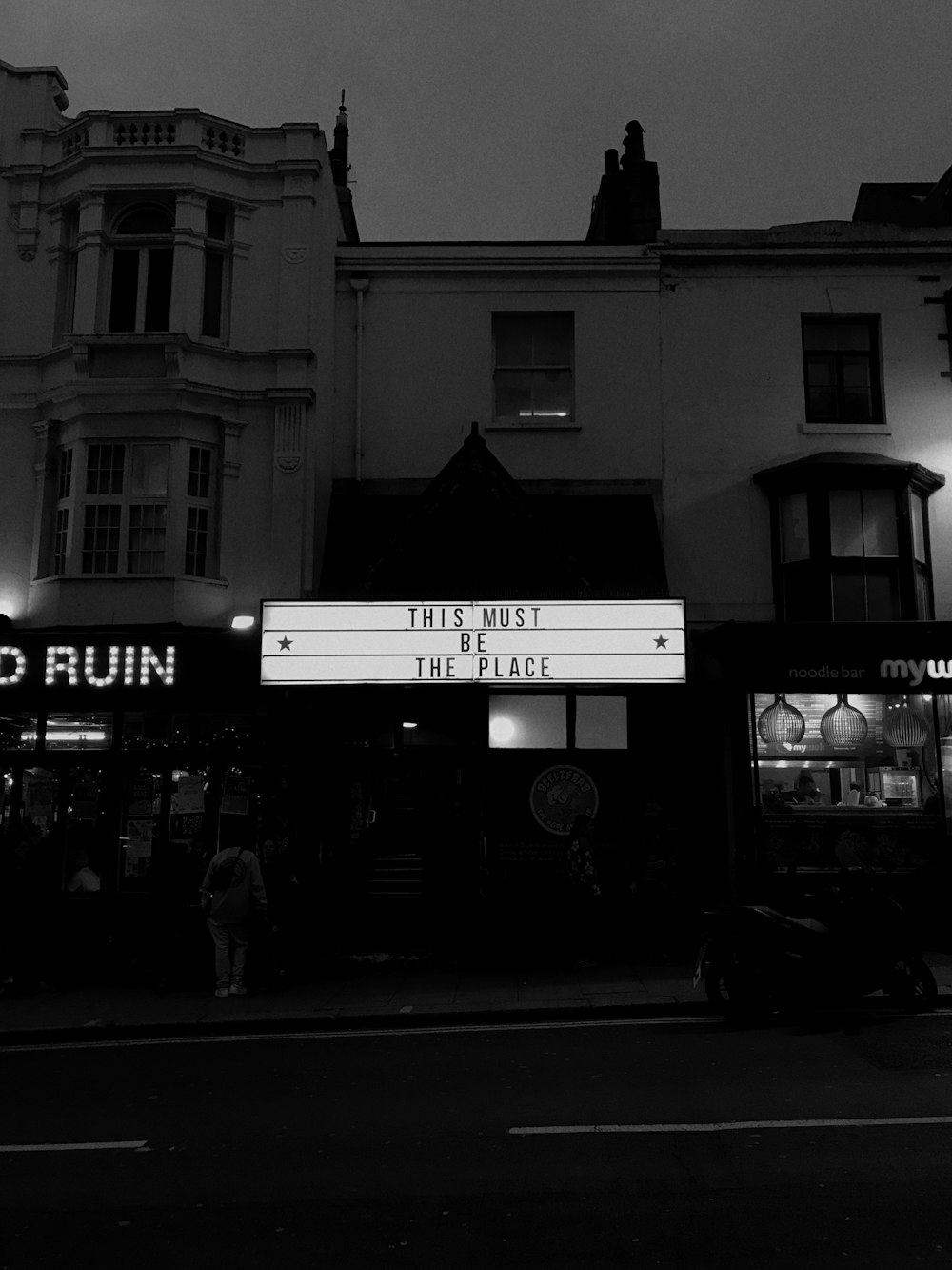 turned-on white store signage at night