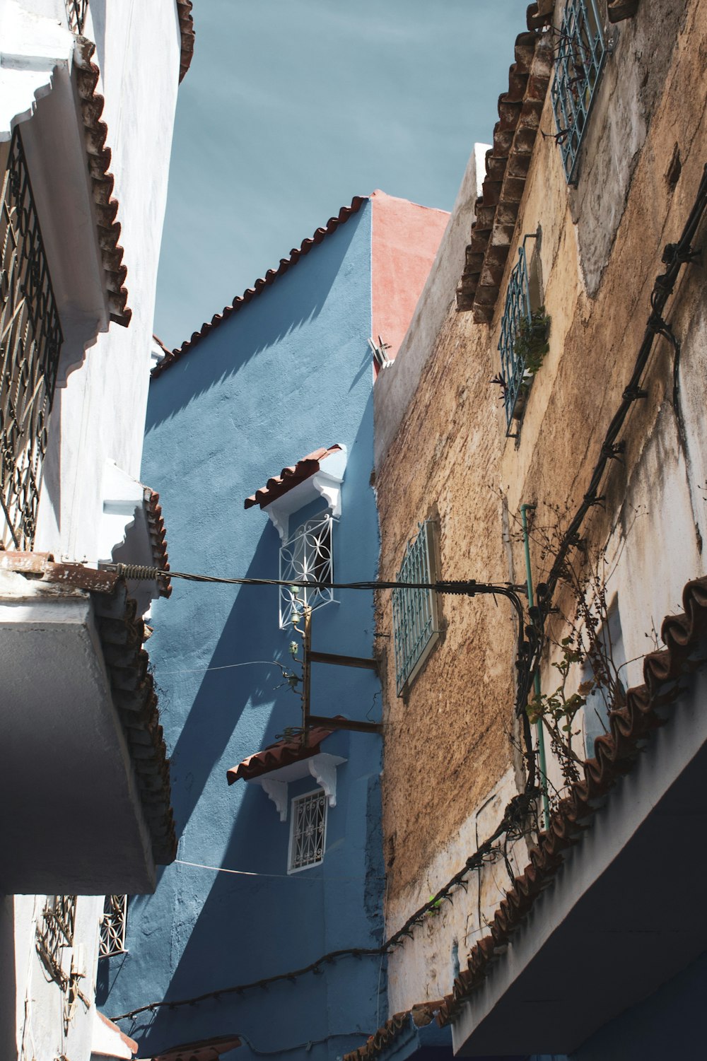 blue and brown concrete buildings under blue and white sky during daytime