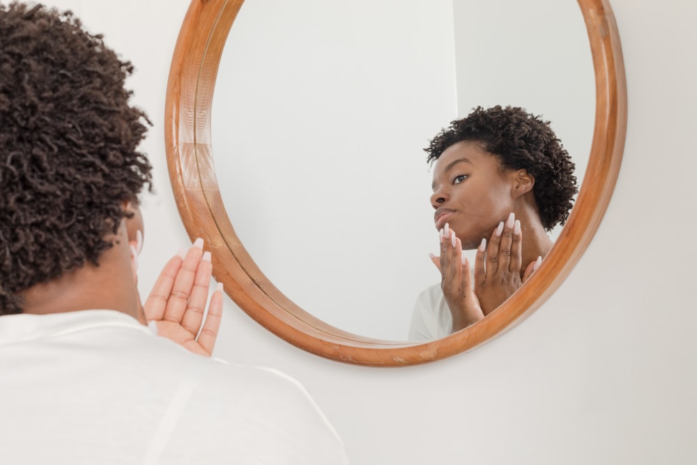 man wearing white shirt facing on wall mirror